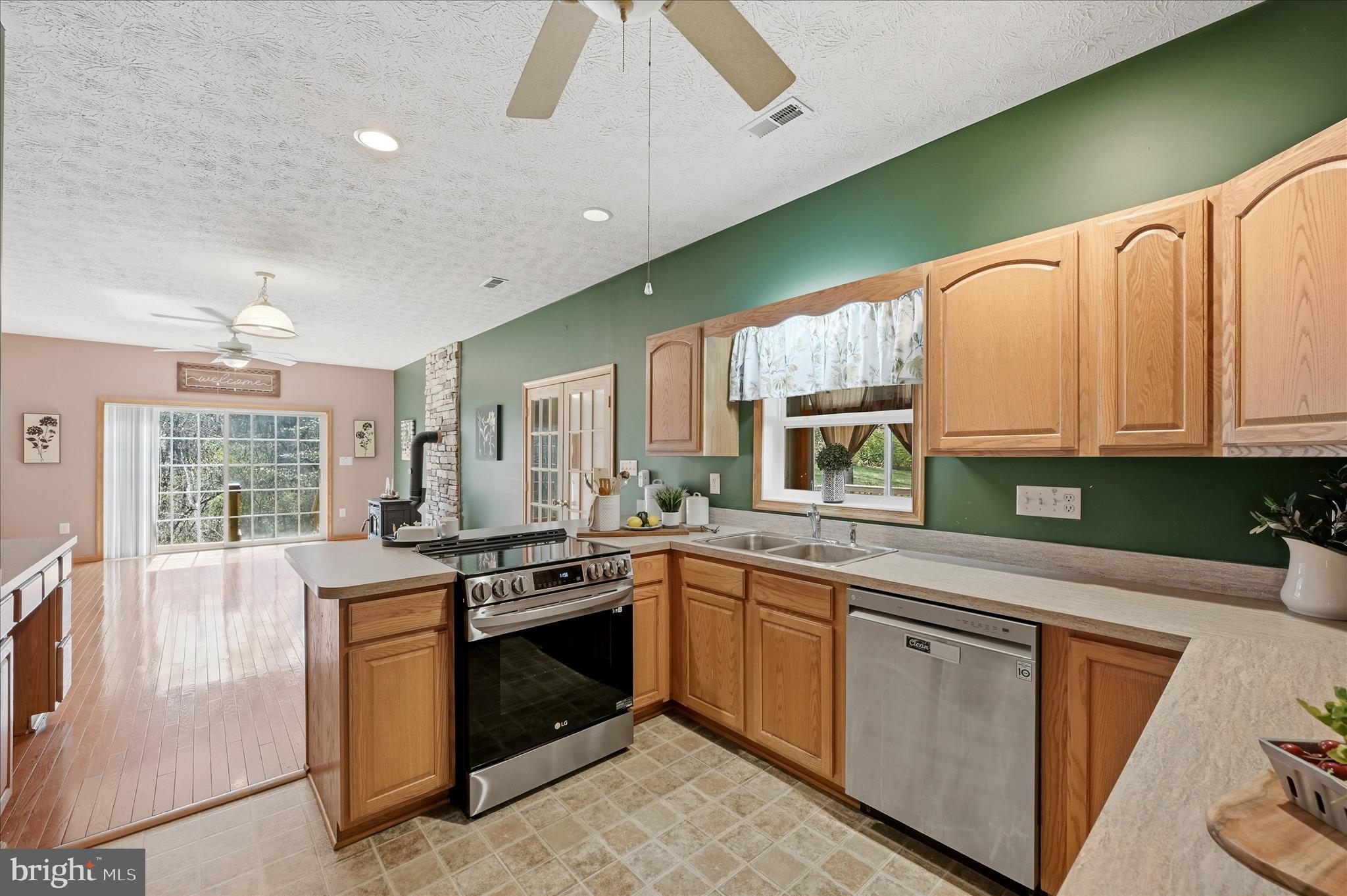 622 Co Rte 25/7 Charles Town, WV 25414 - Photo 18 of 54 a kitchen with stainless steel appliances granite countertop a stove sink and cabinets