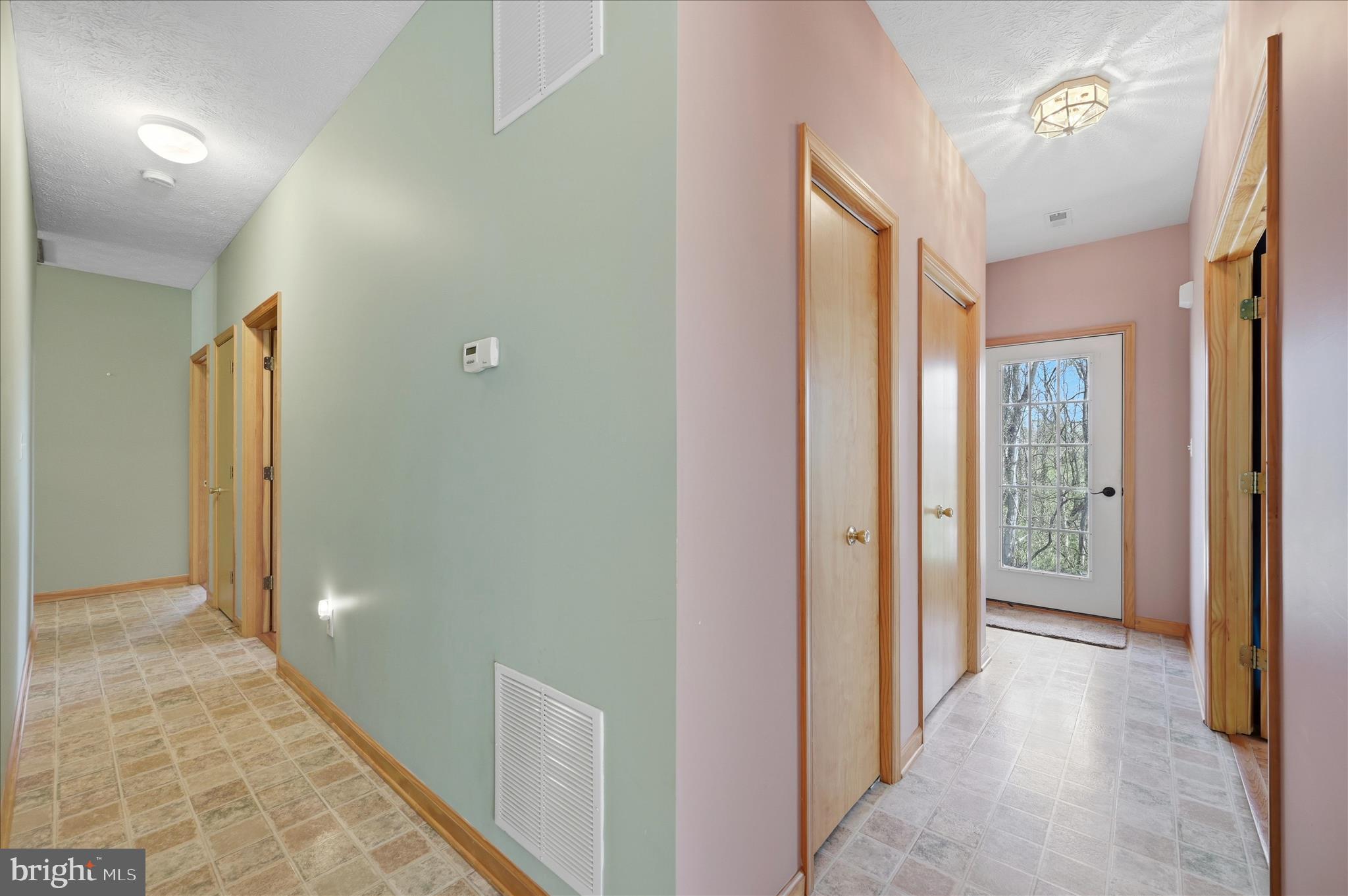 622 Co Rte 25/7 Charles Town, WV 25414 - Photo 25 of 54 a view of a hallway with wooden floor and glass door