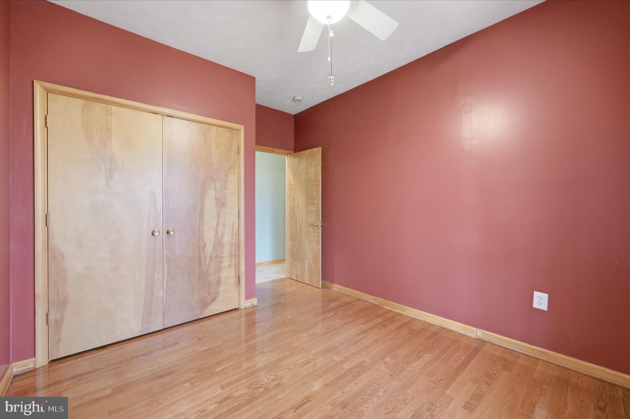 622 Co Rte 25/7 Charles Town, WV 25414 - Photo 30 of 54 an empty room with wooden floor and windows