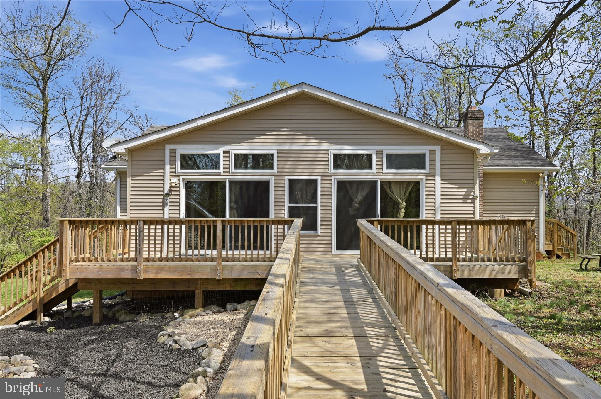 622 Co Rte 25/7 Charles Town, WV 25414 - Photo 36 of 54 a view of a house with a wooden deck and a backyard