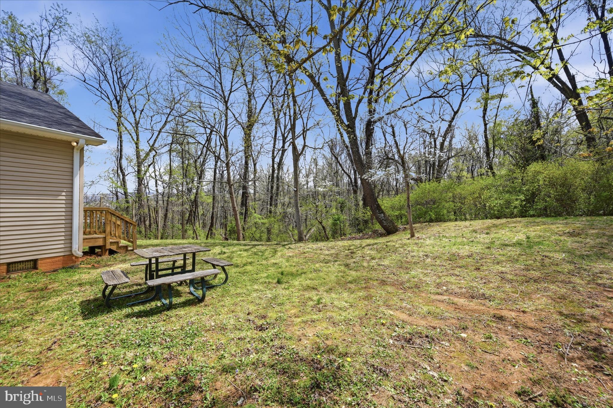 622 Co Rte 25/7 Charles Town, WV 25414 - Photo 41 of 54 a backyard of a house with a fountain and large trees