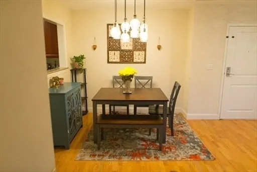 a dining room with furniture a rug and a chandelier