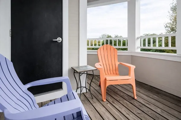a view of a balcony with chairs