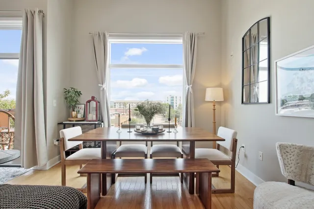 a view of a dining room with furniture wooden floor and a chandelier