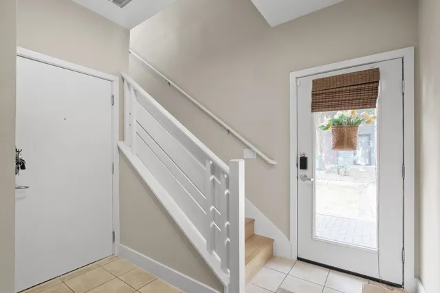 a view of staircase with white walls and a window