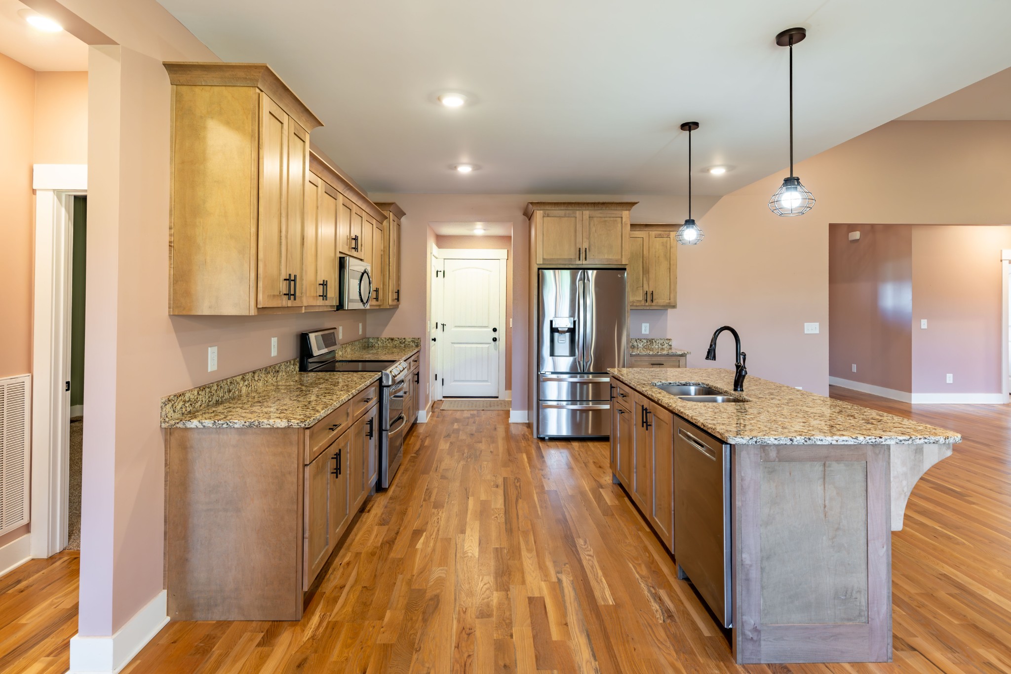 1202 Goose Drive Springfield, TN 37172 - Photo 20 of 45 a large kitchen with stainless steel appliances granite countertop a stove a sink dishwasher and a refrigerator with wooden floor