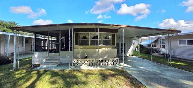 a backyard of a house with table and chairs