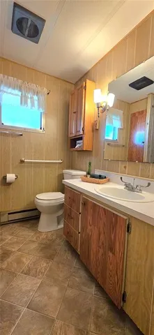 a view of a house with a big yard and large trees