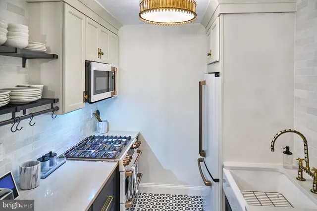 a kitchen with a sink a stove and a refrigerator
