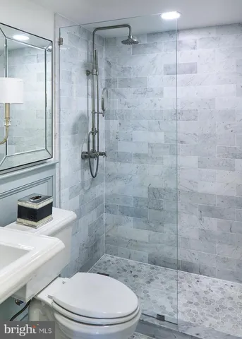 a bathroom with a toilet and a shower