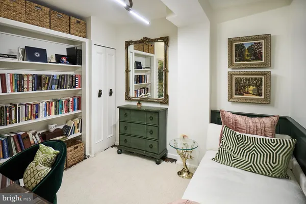 a bedroom with furniture and a book shelf