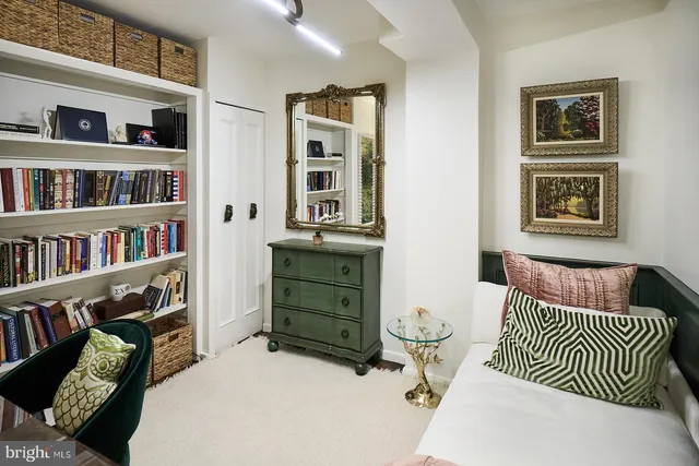 a bedroom with furniture and a book shelf