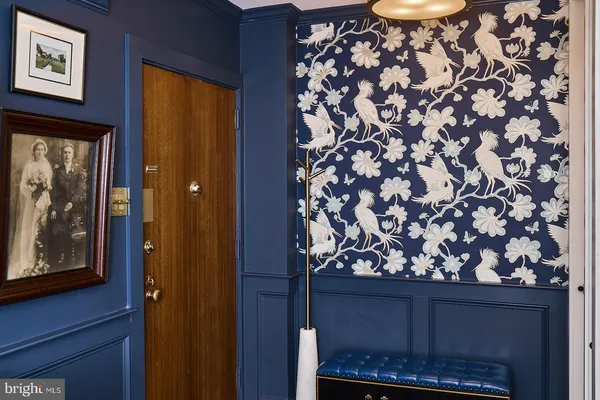 a room with a door and a painting on the wall