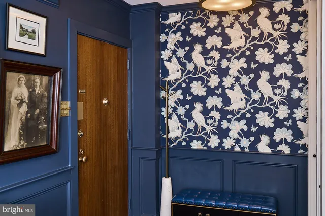 a room with a door and a painting on the wall