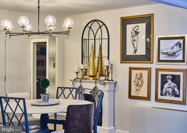 a view of a dining room with furniture chandelier and a mirror