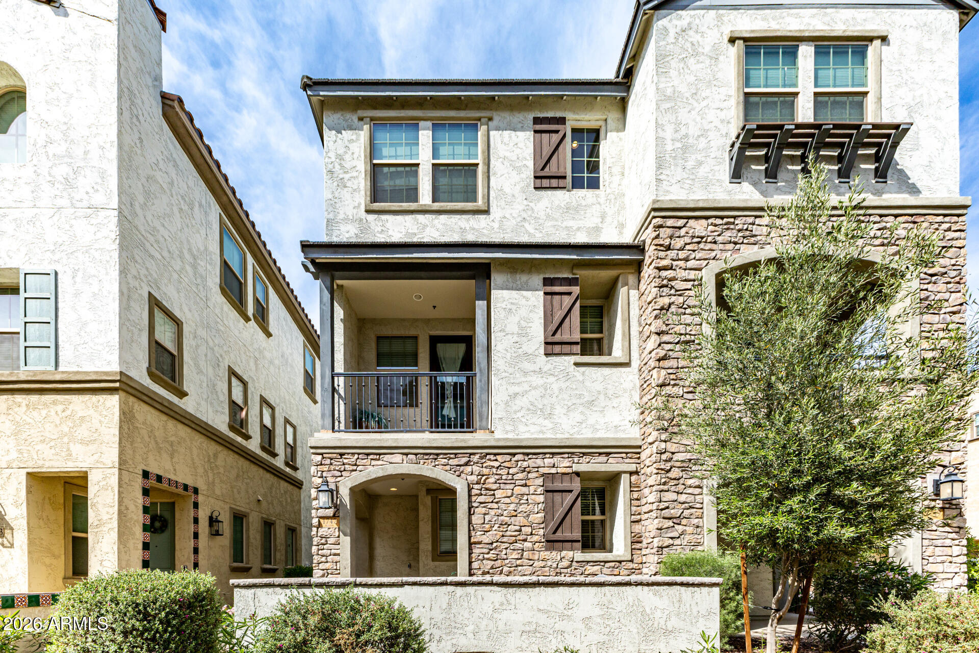 1747 East Chelsea Lane Gilbert, AZ 85295 - Photo 1 of 30 a front view of a residential apartment building with a yard