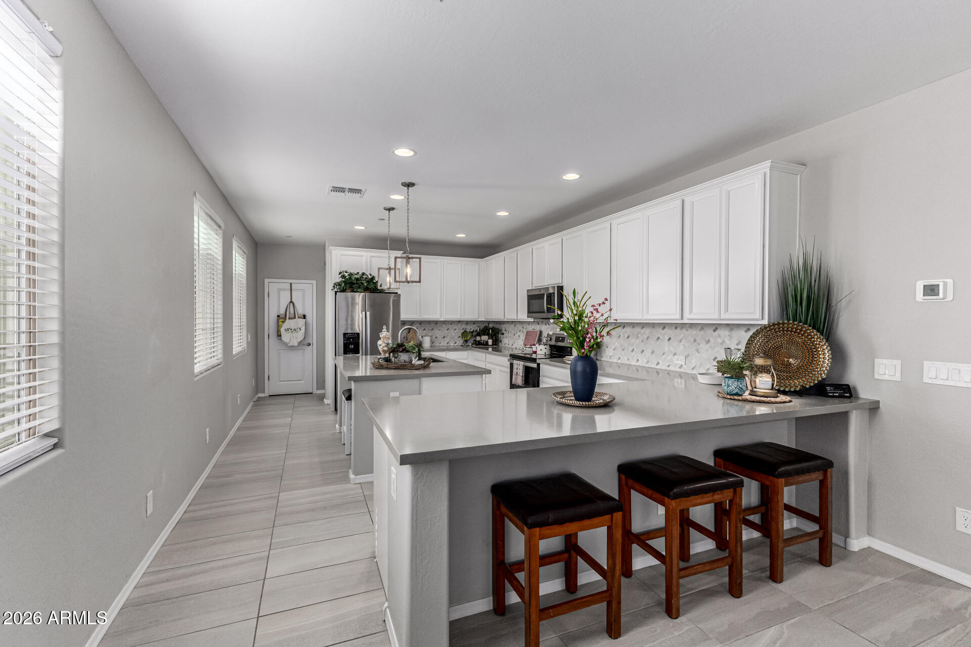 1747 East Chelsea Lane Gilbert, AZ 85295 - Photo 11 of 30 a kitchen with stainless steel appliances kitchen island granite countertop a sink and cabinets
