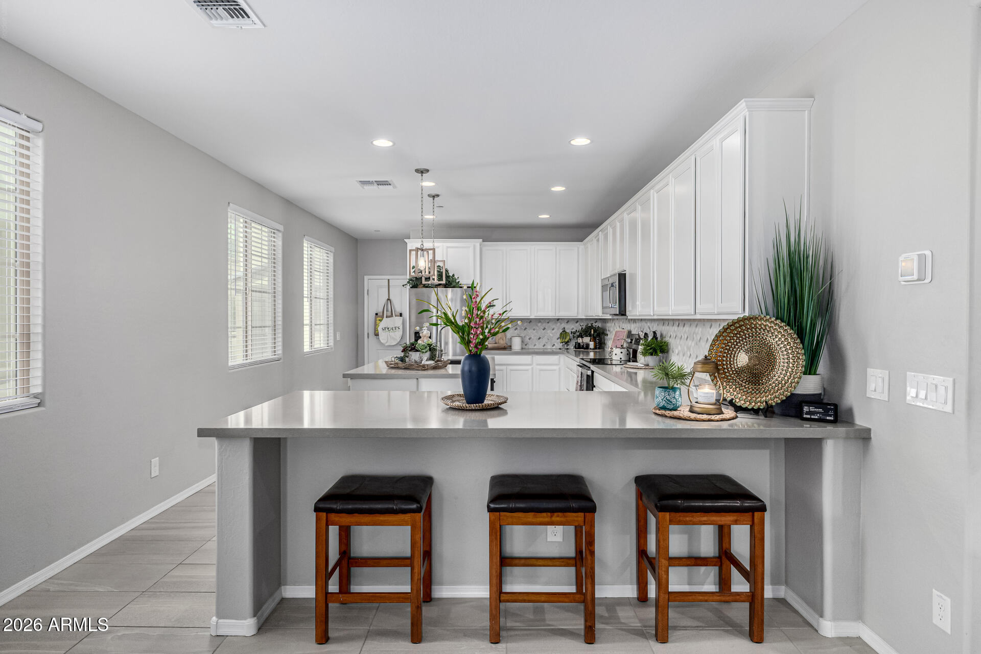 1747 East Chelsea Lane Gilbert, AZ 85295 - Photo 10 of 30 a kitchen with stainless steel appliances a table and chairs
