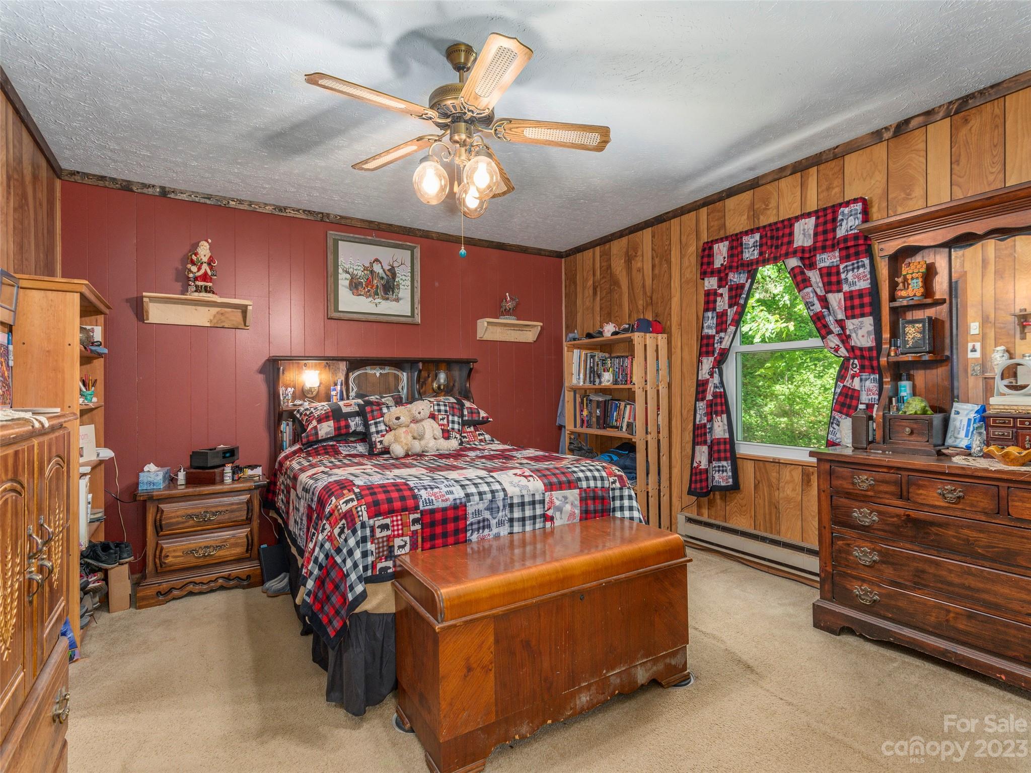 291 Dickinson Drive Clyde, NC 28721 - Photo 13 of 27 a bedroom with a bed and a large window