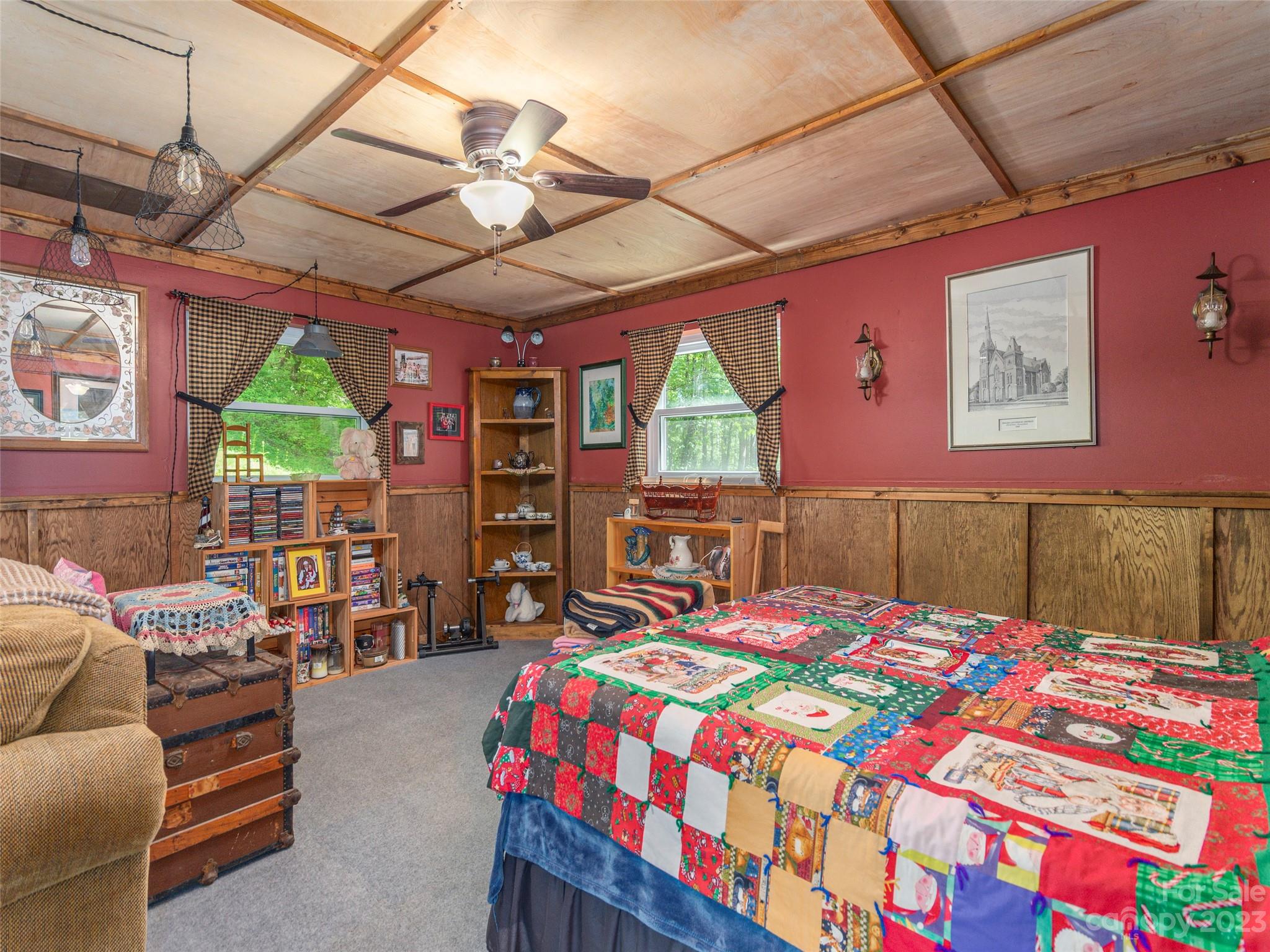291 Dickinson Drive Clyde, NC 28721 - Photo 16 of 27 a bedroom with a bed a chandelier and a flat tv screen on the wall