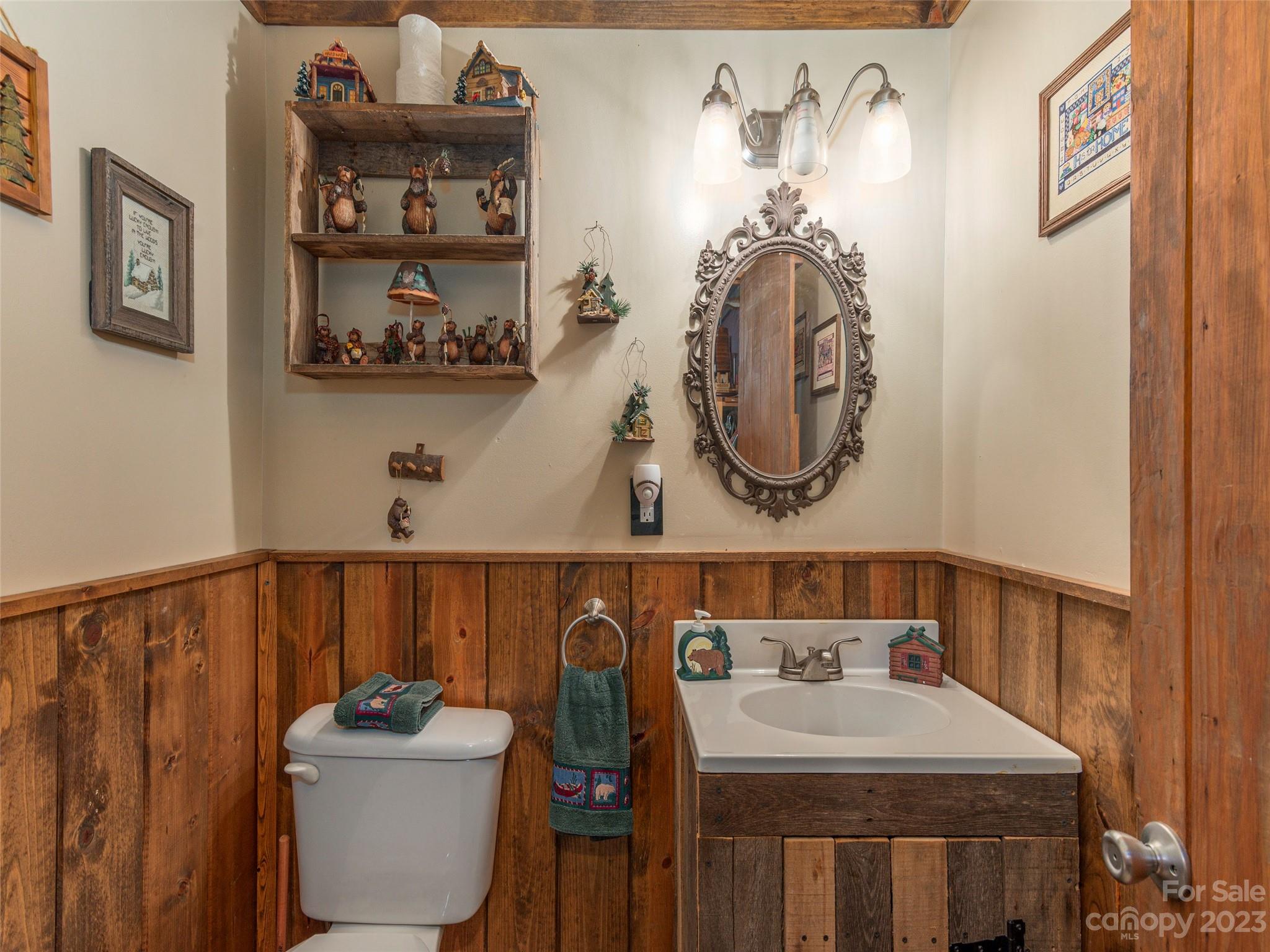 291 Dickinson Drive Clyde, NC 28721 - Photo 18 of 27 a bathroom with a sink mirror and toilet