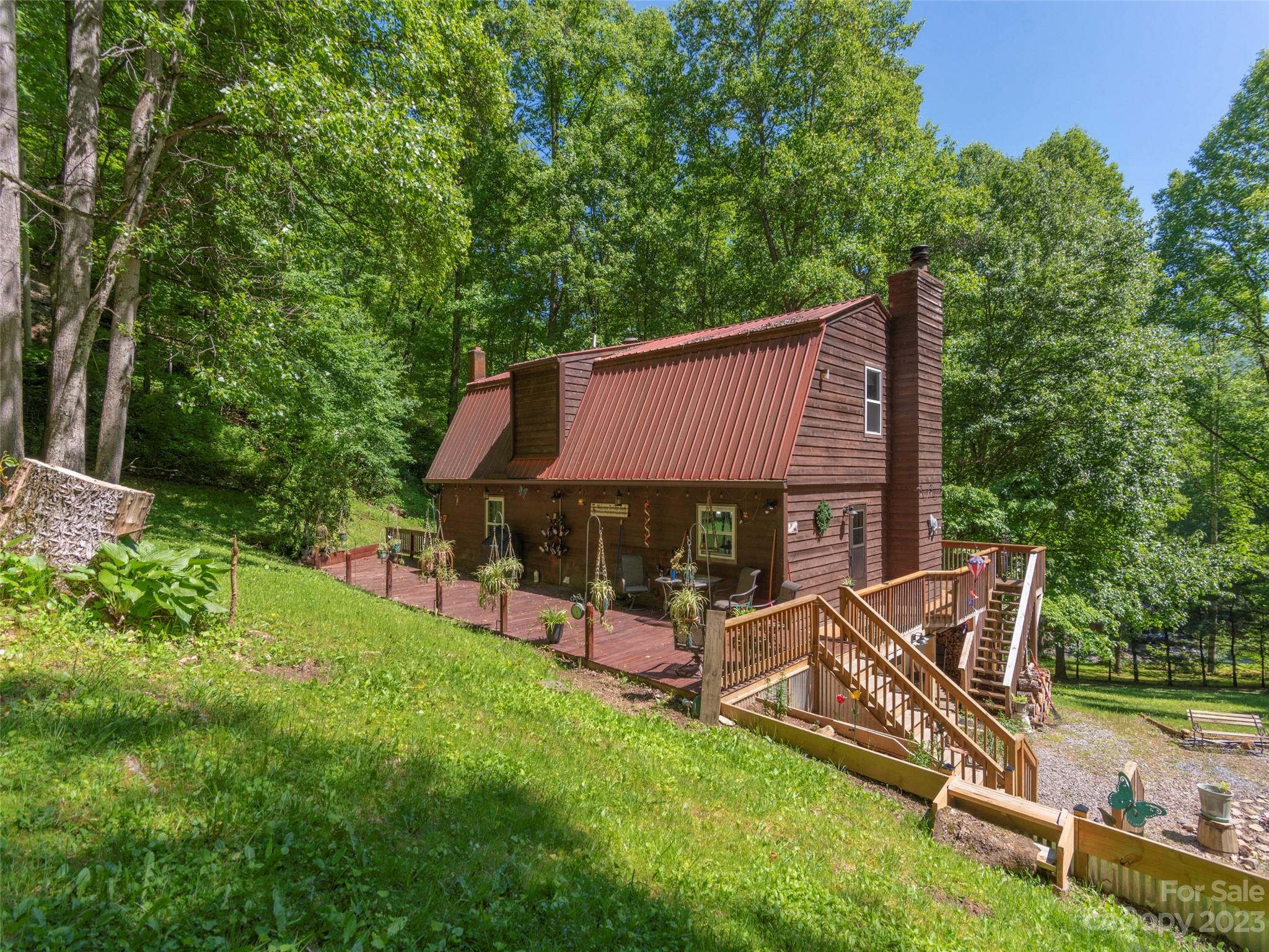 291 Dickinson Drive Clyde, NC 28721 - Photo 2 of 27 an outdoor sitting area with golf course