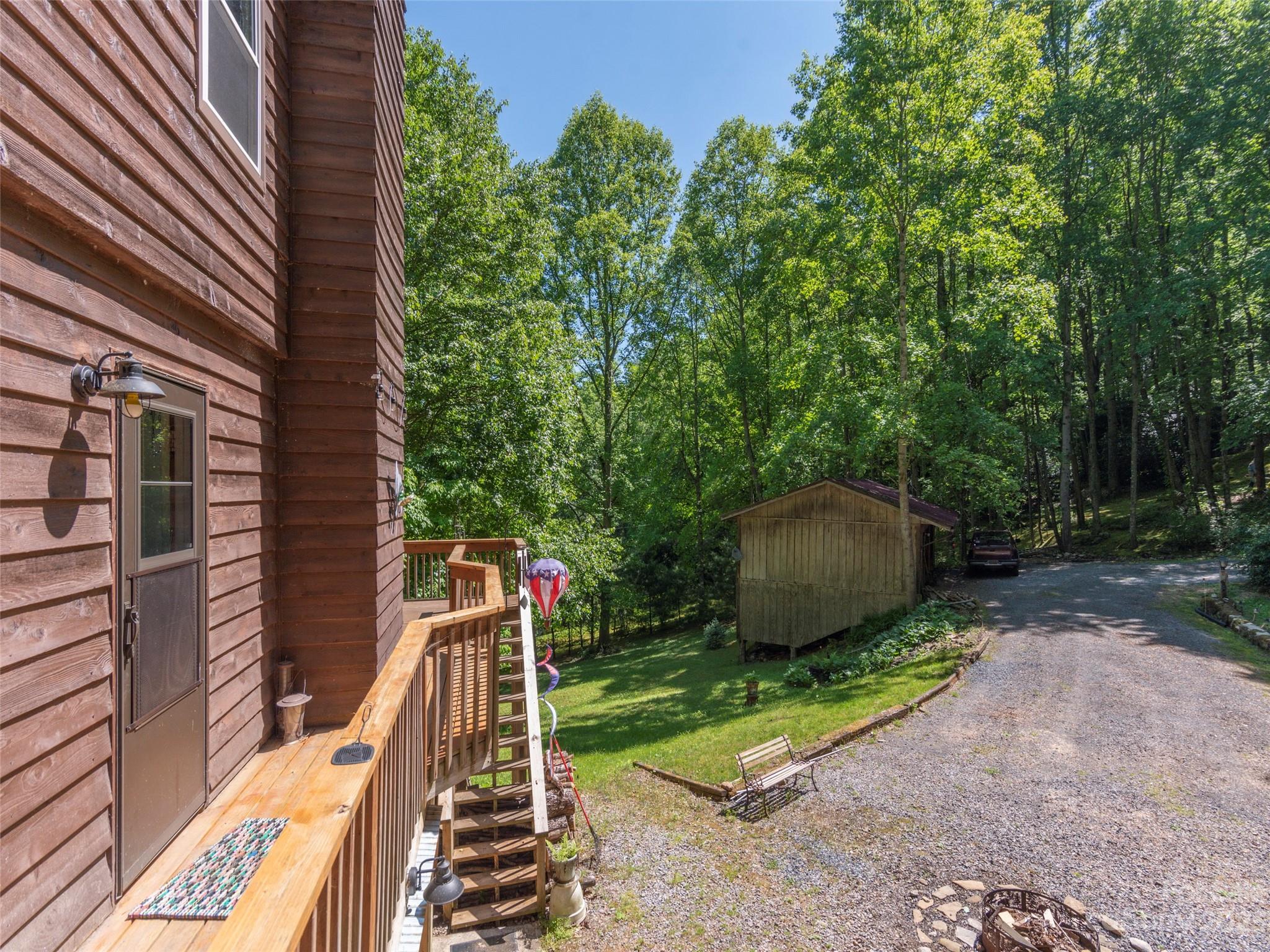 291 Dickinson Drive Clyde, NC 28721 - Photo 22 of 27 a view of a chair and fire pit in the backyard