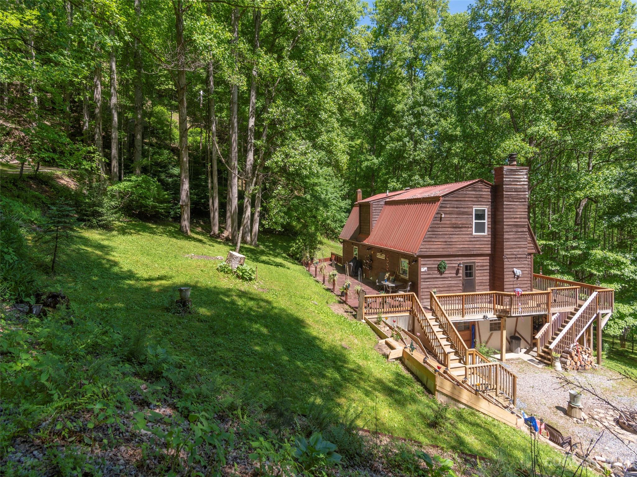 291 Dickinson Drive Clyde, NC 28721 - Photo 26 of 27 a view of a house with backyard and sitting area