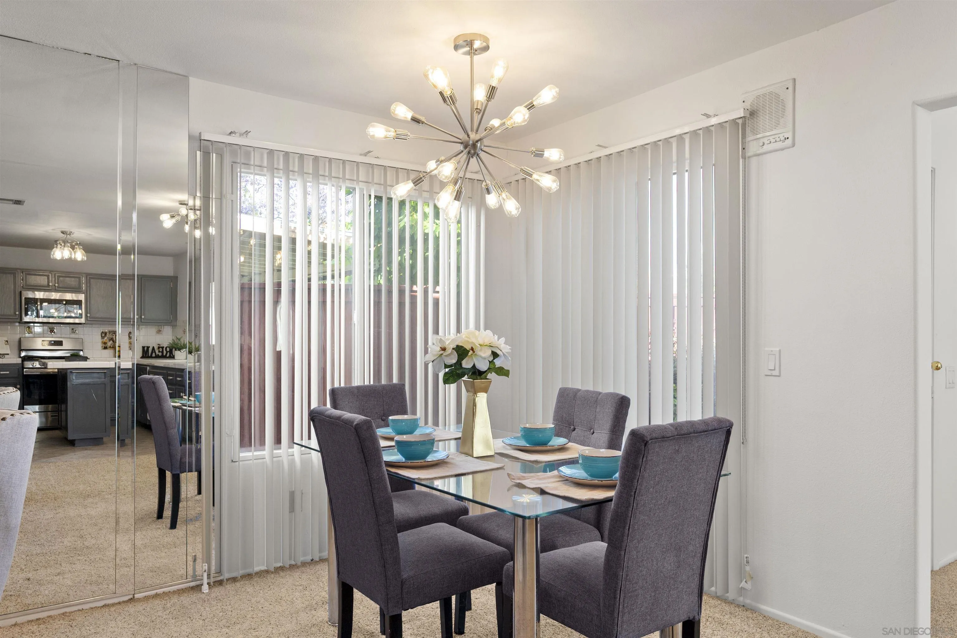 4815 Ebony Ridge Road San Diego, CA 92102 - Photo 15 of 45 a dining room with furniture a chandelier and a rug