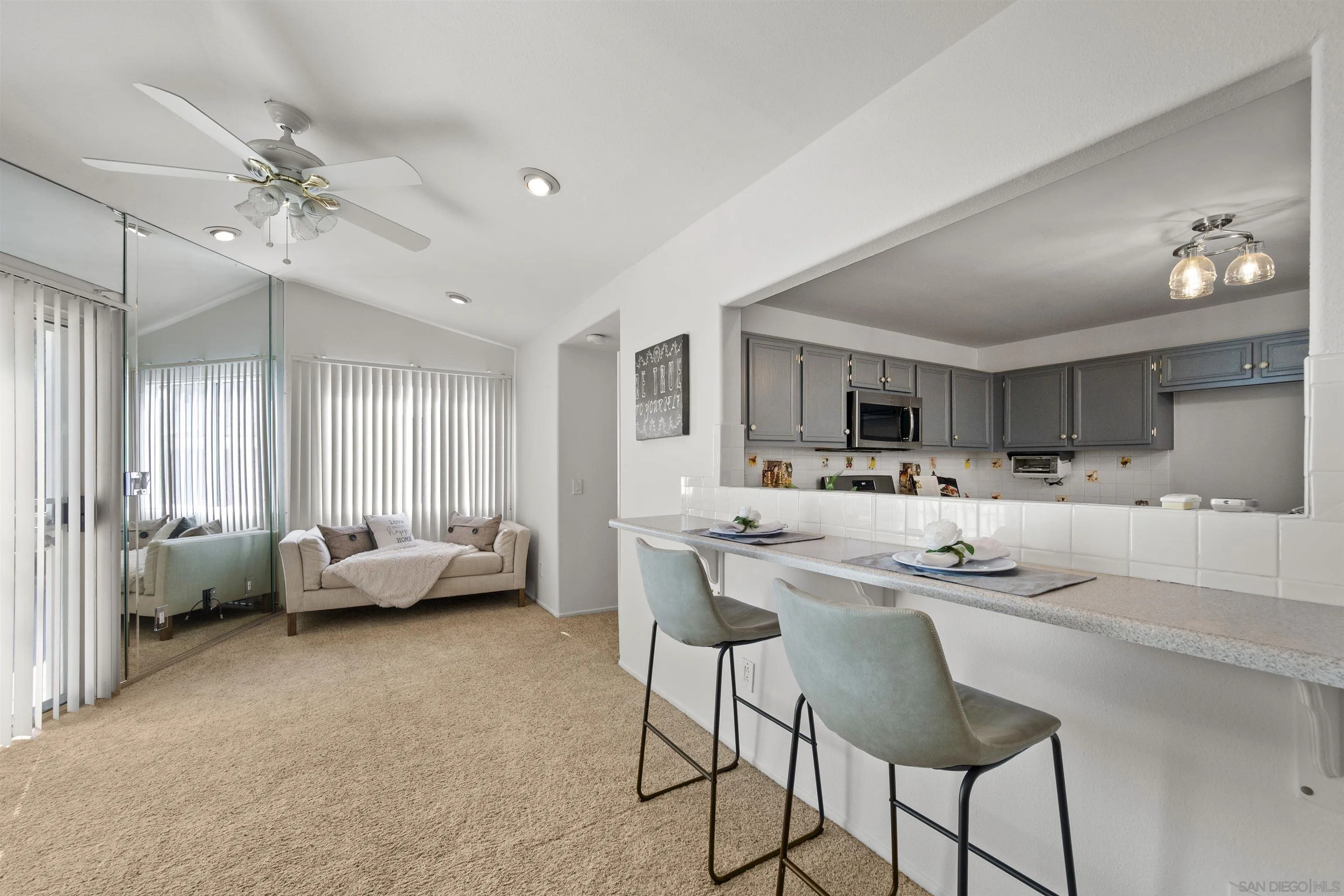 4815 Ebony Ridge Road San Diego, CA 92102 - Photo 23 of 45 a kitchen with a stove a sink a dining table and chairs