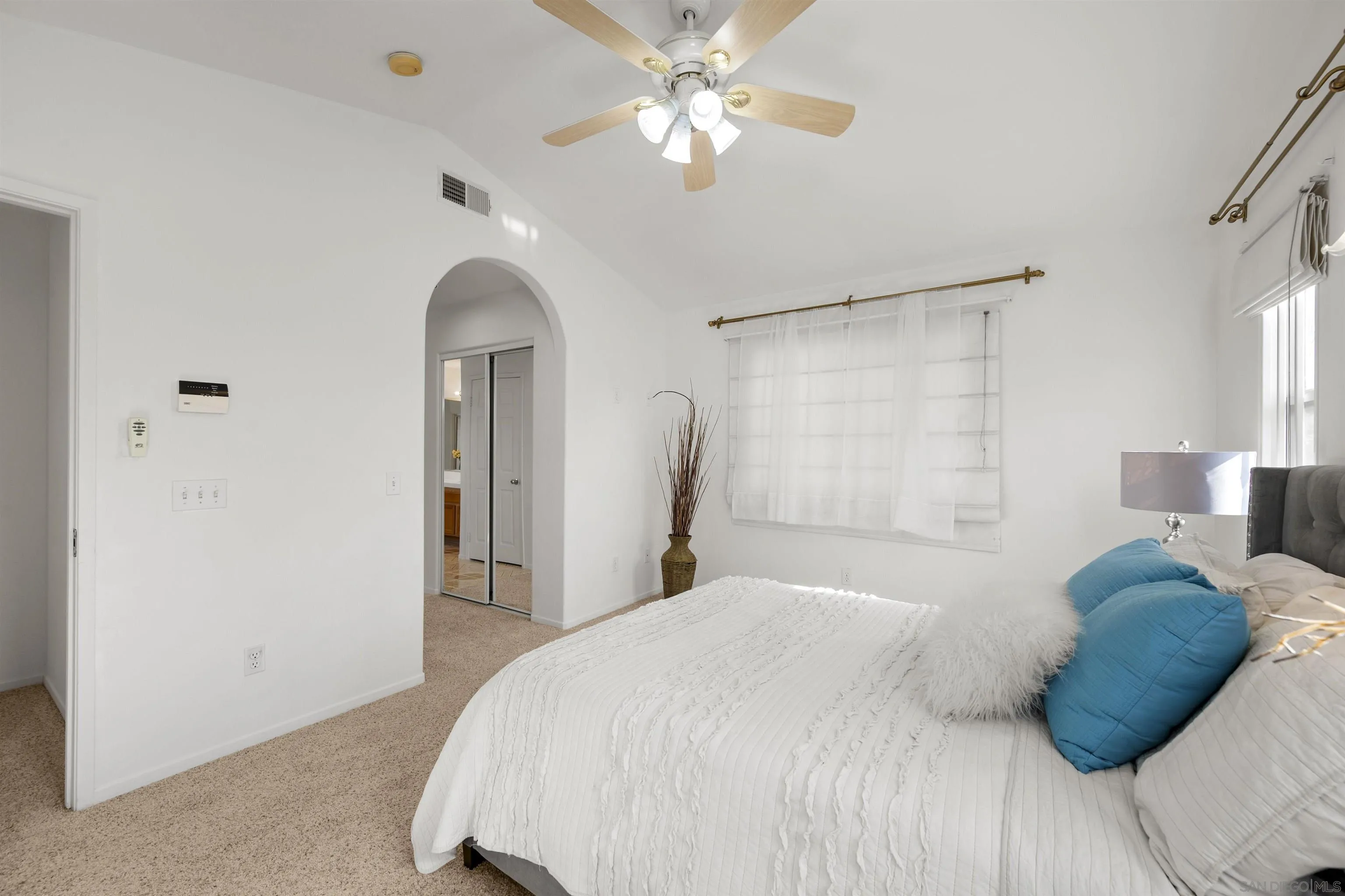 4815 Ebony Ridge Road San Diego, CA 92102 - Photo 29 of 45 a bedroom with a bed and a chandelier