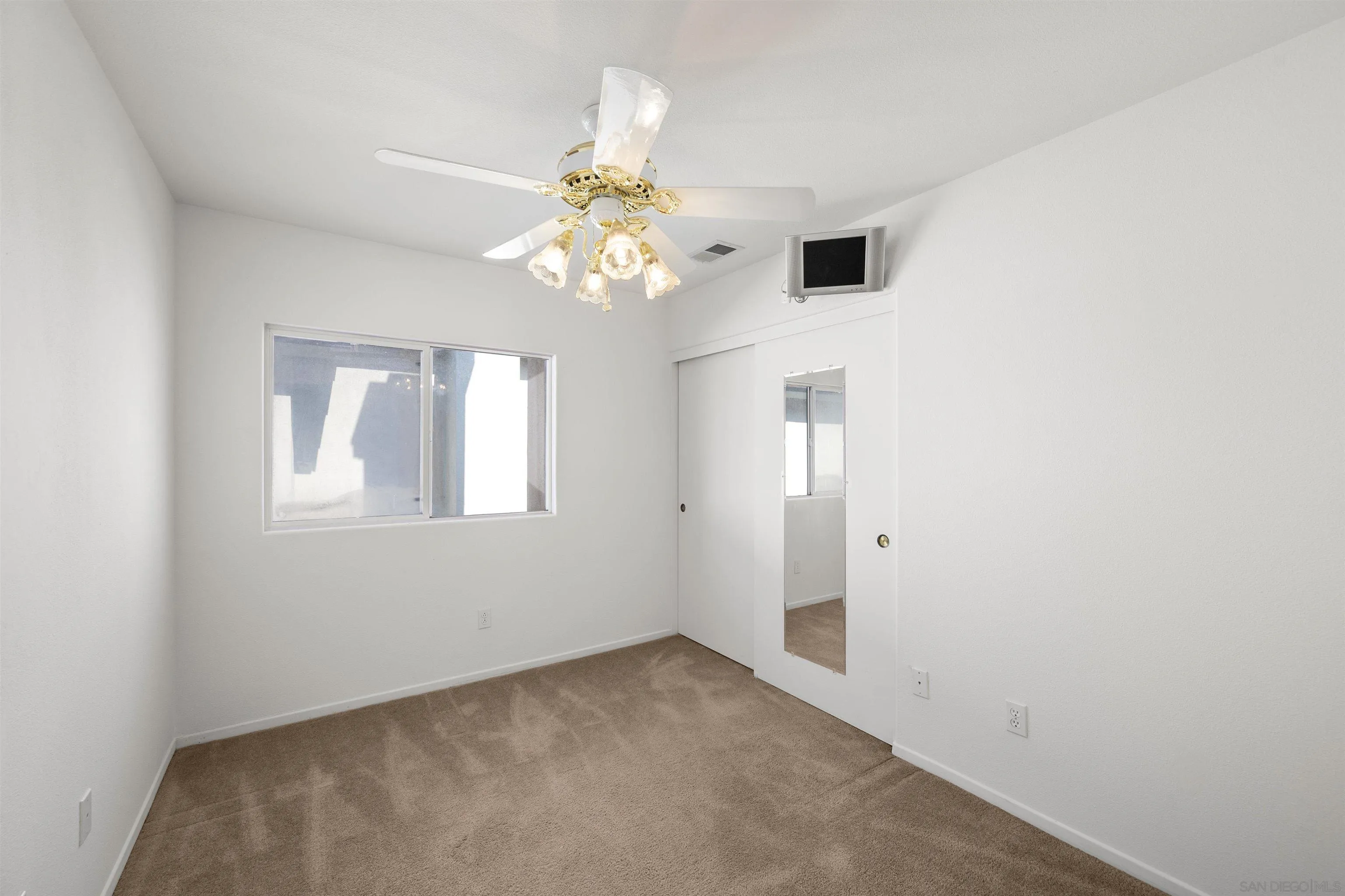 4815 Ebony Ridge Road San Diego, CA 92102 - Photo 33 of 45 en empty room with windows and chandelier