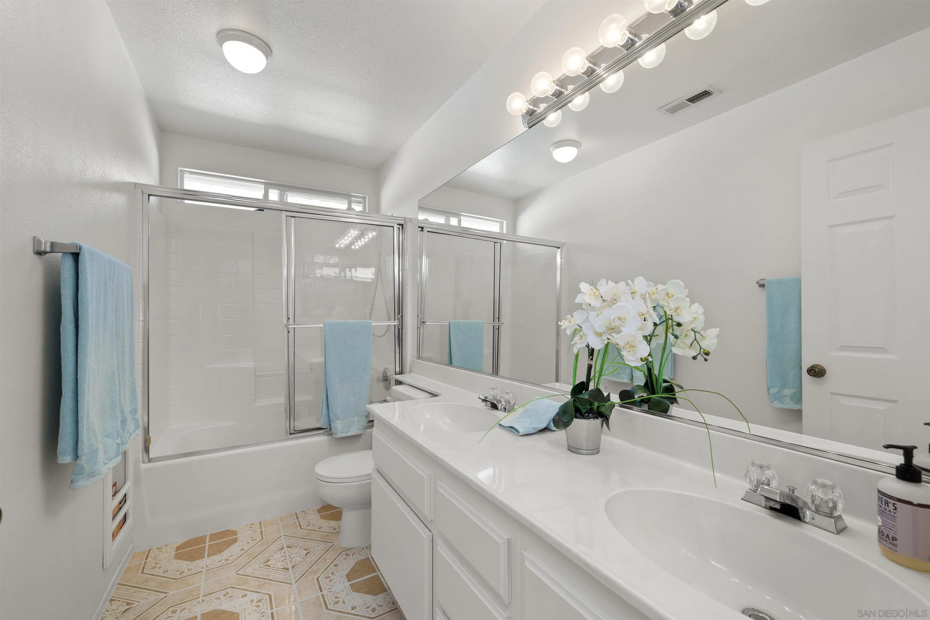 4815 Ebony Ridge Road San Diego, CA 92102 - Photo 35 of 45 a bathroom with a granite countertop sink a toilet and shower
