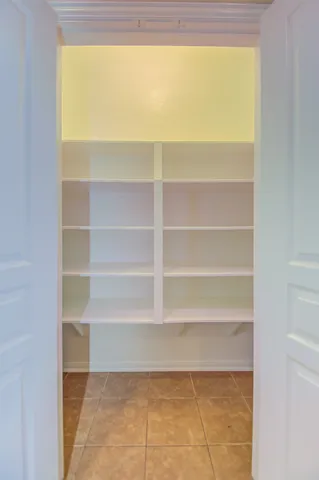 a view of walk in closet with empty racks