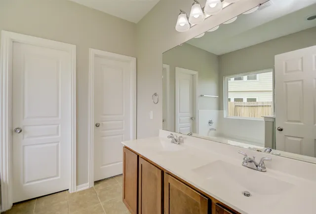 a bathroom with a sink vanity and a mirror