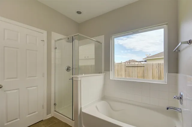 a bathroom with a bathtub and a shower