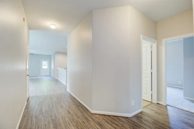 a view of a room with wooden floor