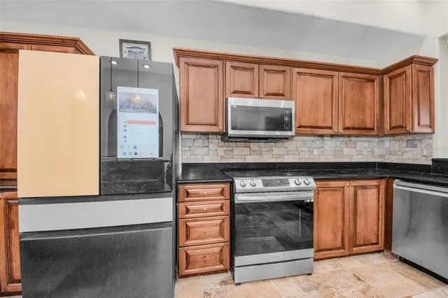 a living room with furniture a fireplace and a large window