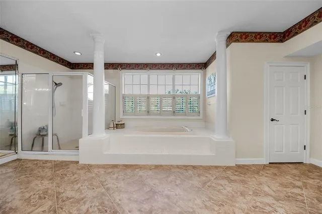 a living room with wooden floor and a fireplace