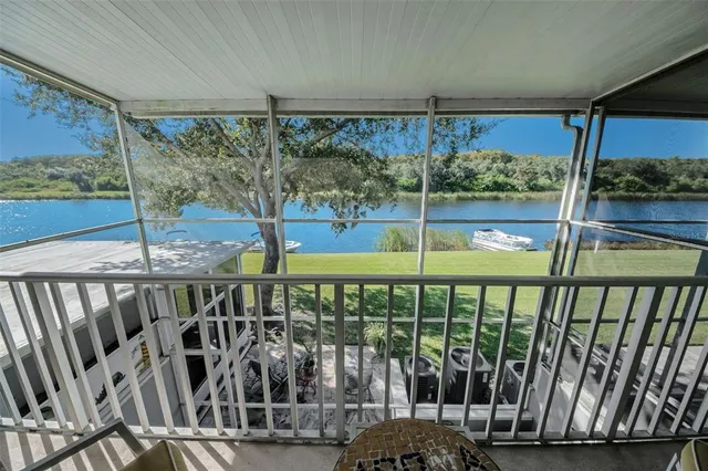 a view of a lake with a table and chairs