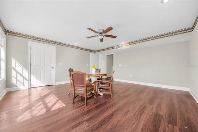 a view of a lake with a table and chairs under an umbrella