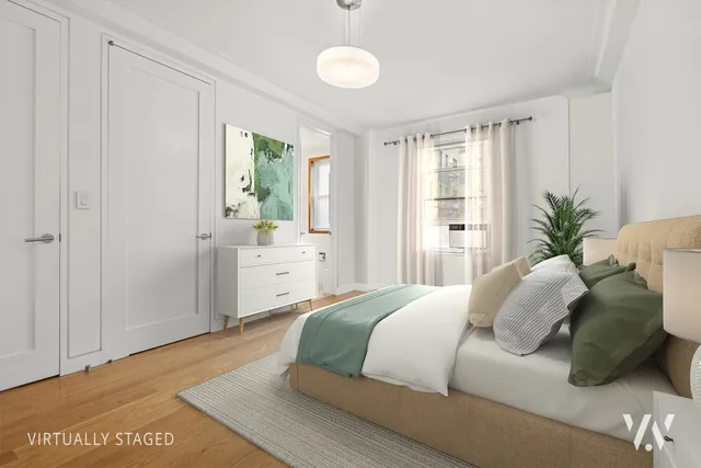 a bedroom with a bed and a potted plant