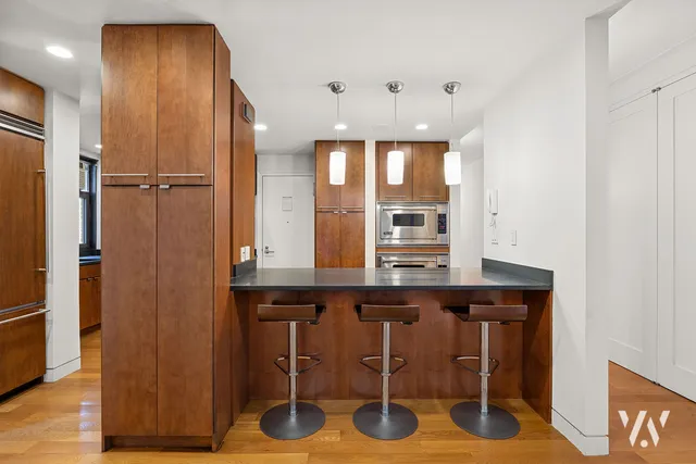 a kitchen with a wooden cabinets and chairs
