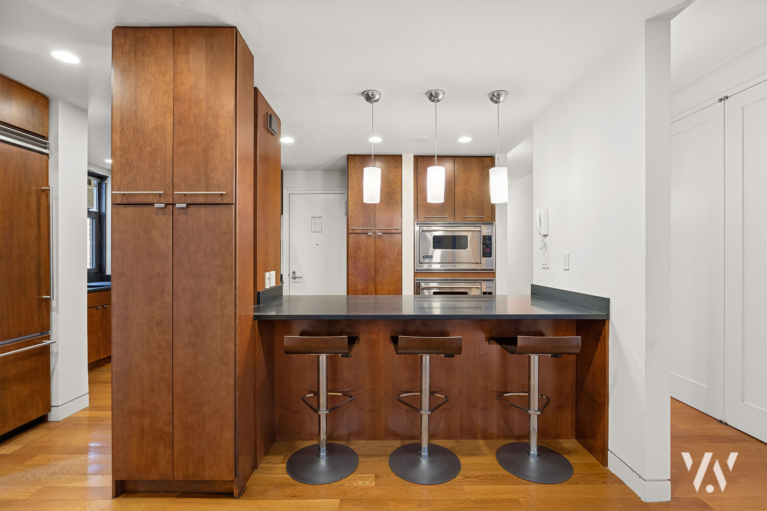 800 West End Avenue, Unit 12B Manhattan, NY 10025 - Photo 5 of 19 a kitchen with a wooden cabinets and chairs