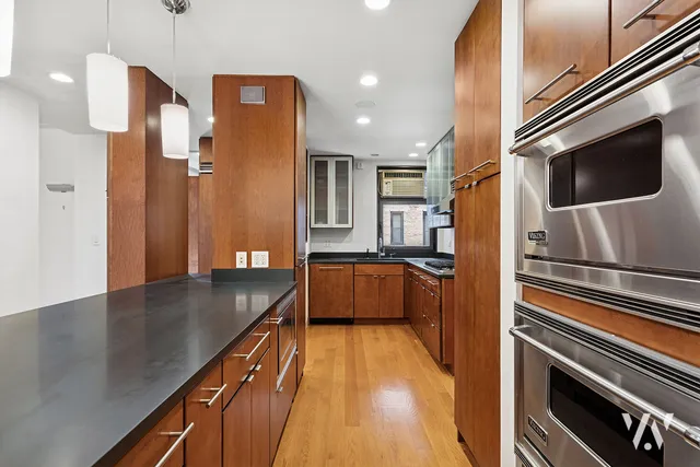 a kitchen with stainless steel appliances a refrigerator a sink and stove