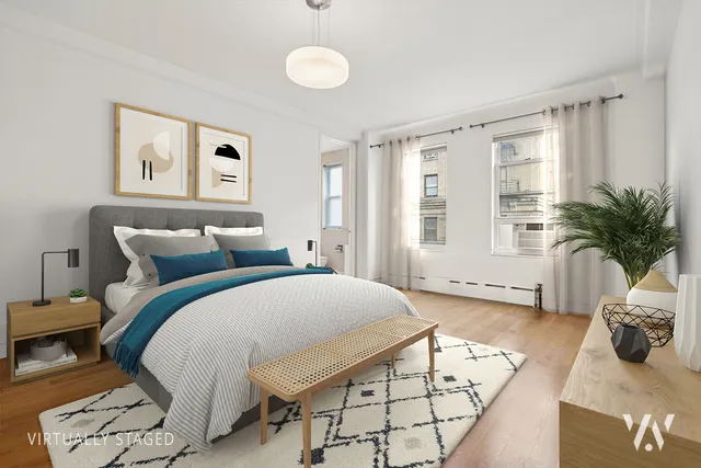 a spacious bedroom with a bed a couch and potted plant