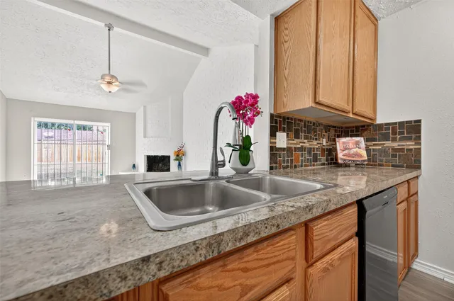 a kitchen with sink refrigerator and window