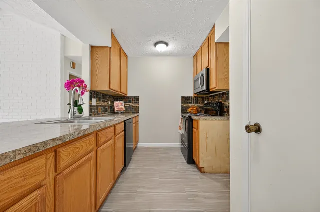 a kitchen with stainless steel appliances granite countertop a stove and a microwave