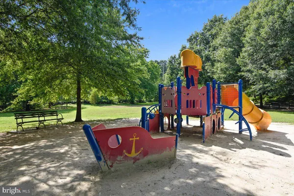 a view of park with bench and trees