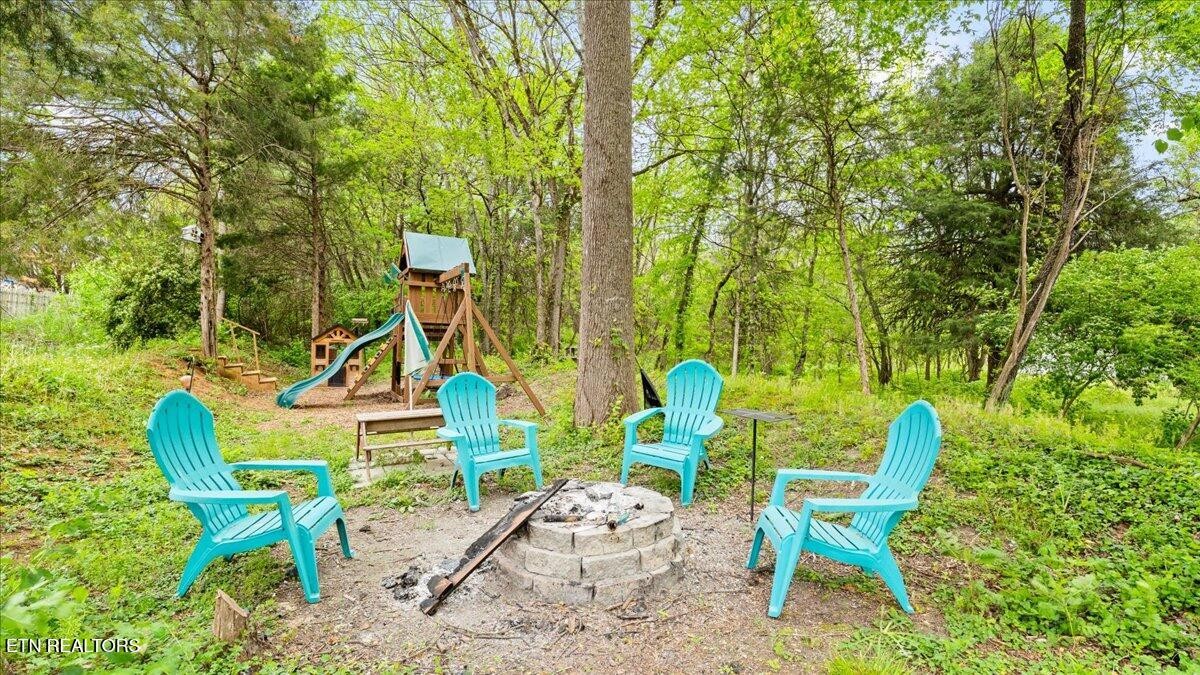 1816 River Poppy Road Mascot, TN 37806 - Photo 1 of 52 a view of a chairs and table in backyard